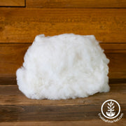 Cotton Fiber Red Beauty wooden surface.