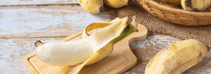 peeled banana sitting on a cutting board