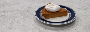 slice of crustless pumpkin pie on a plate white background