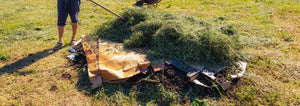 layering plant cuttings and cardboard for lasagna garden preparation