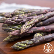 Sweet Purple asparagus spears on a wood table